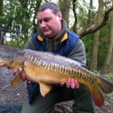 man holding a carp fish
