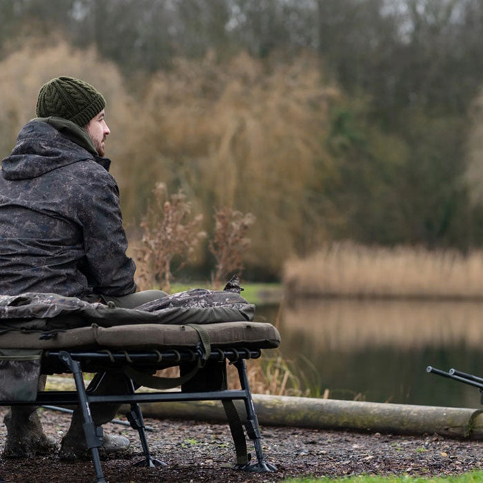 man carp fishing by the river surface